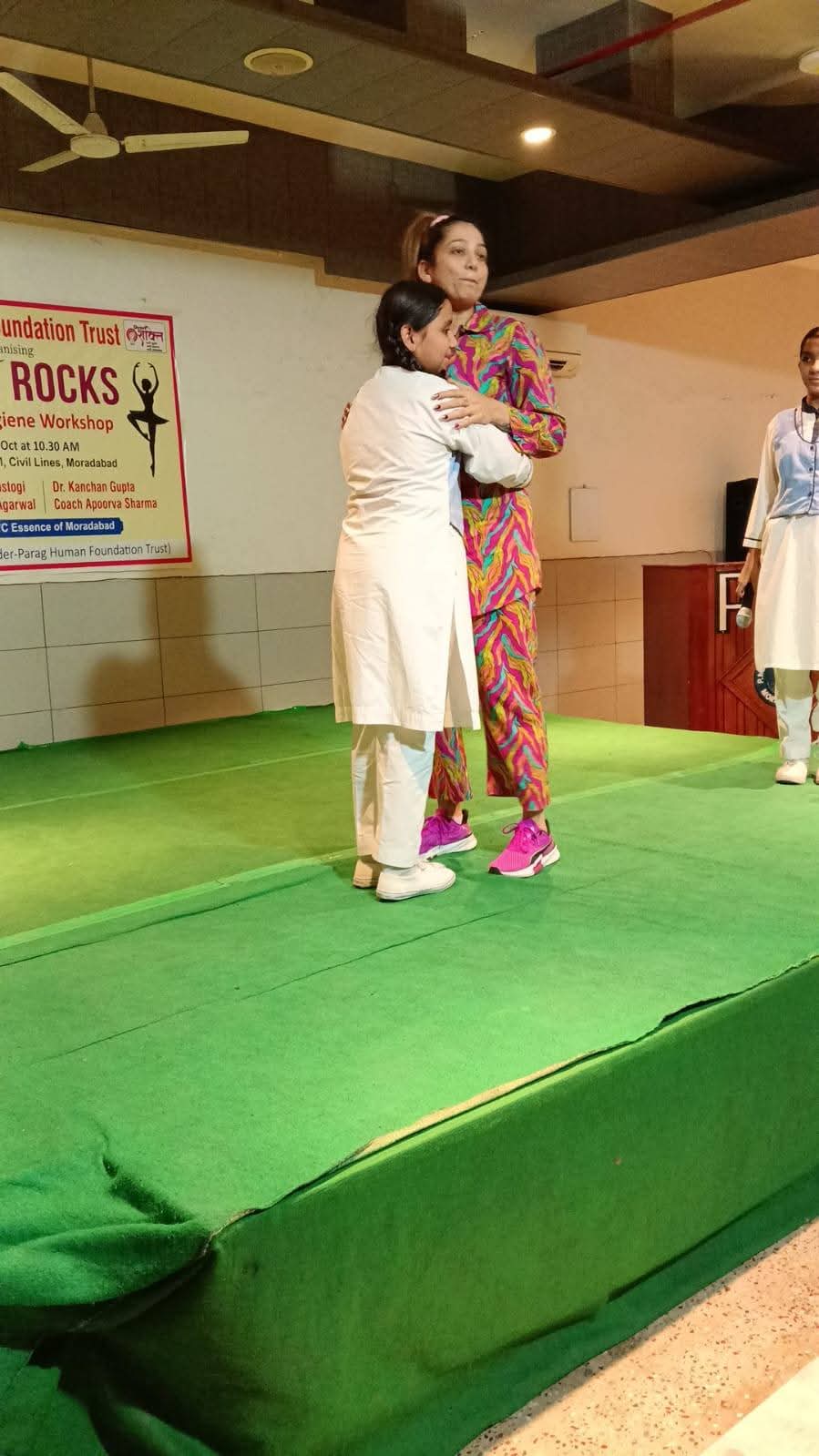Founder President Garima Singh encouraging school student on stage
